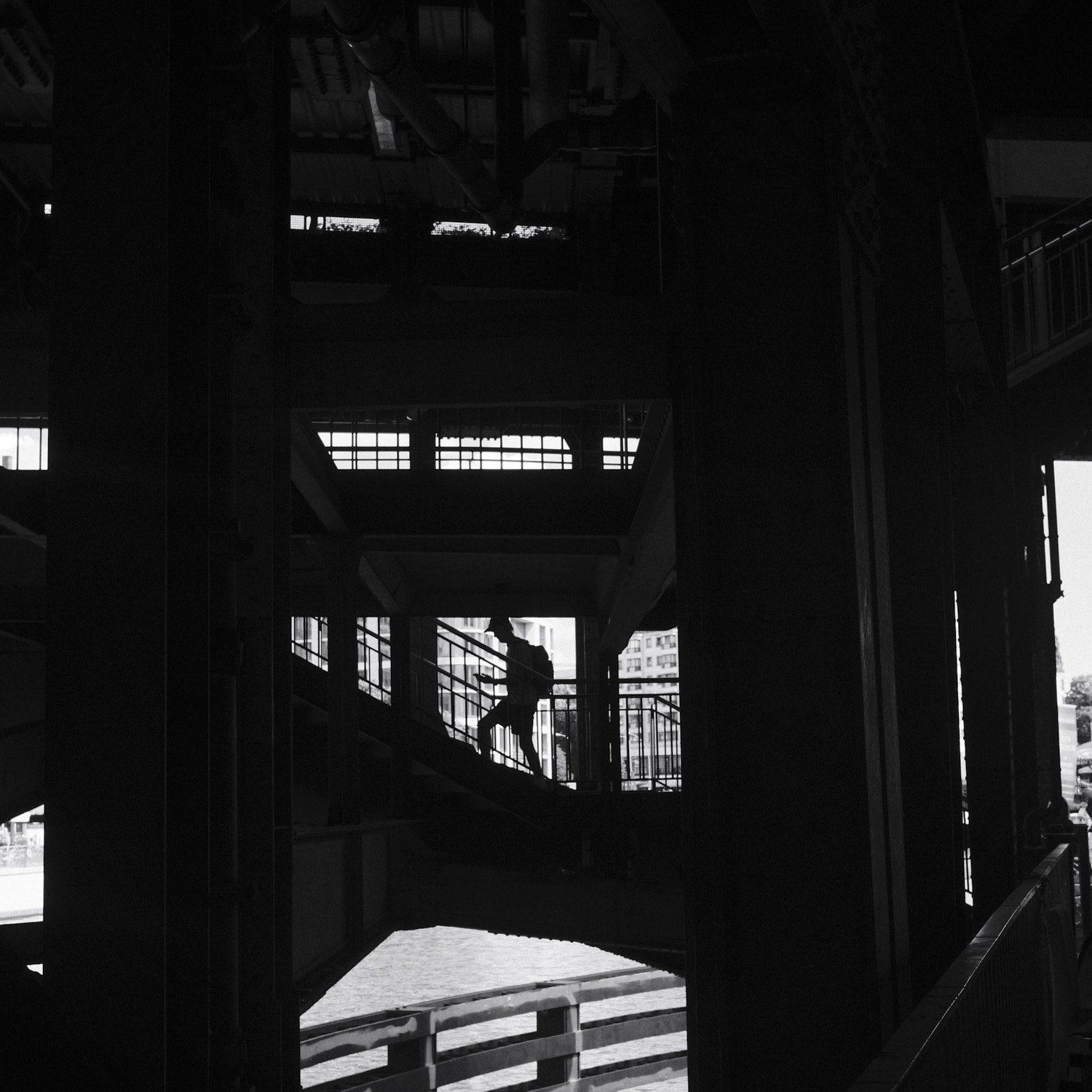 Silhouette of man climbing stairs in dark U-Bahn tunnel at Friedrichstrasse station Berlin